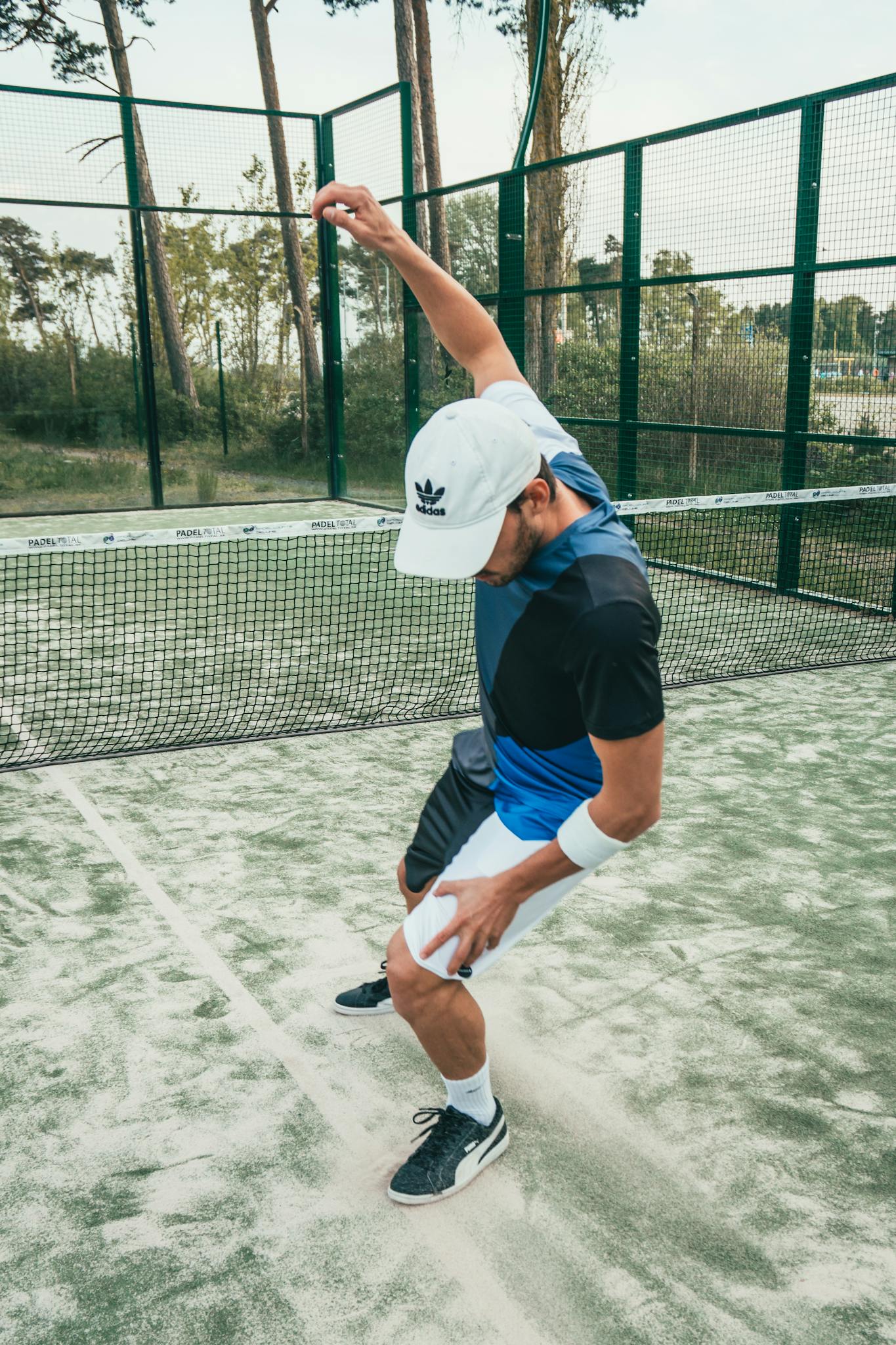 Man in sportswear energetically celebrating on a tennis court.